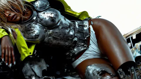 Great artists generate in Superstudio 8 A futuristic person reclining, wearing a silver metal bust and yellow jacket. Artwork by Tyler Givens
